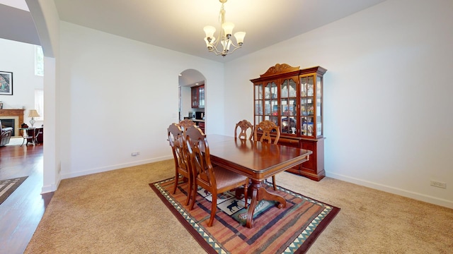 731 W Kenilworth Ave, Palatine, IL 60067 - dining room featuring arched walkways, a chandelier, baseboards, and light colored carpet