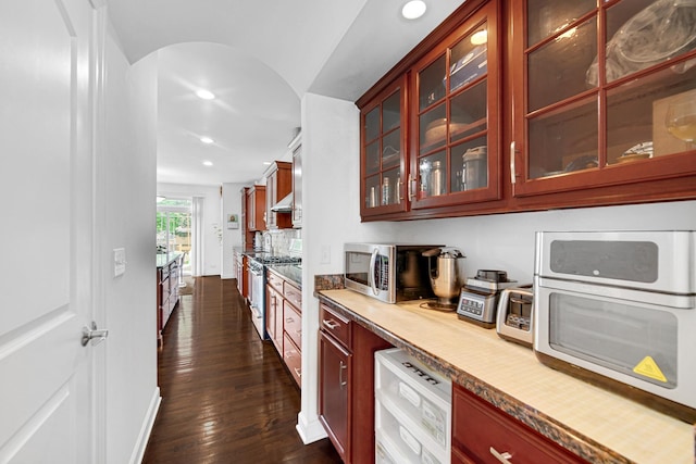 731 W Kenilworth Ave, Palatine, IL 60067 - bar area featuring stainless steel appliances, recessed lighting, dark wood-style floors, arched walkways, and under cabinet range hood