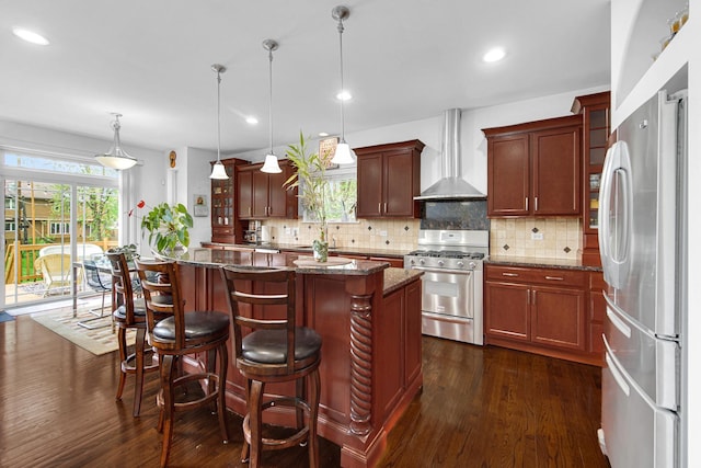 731 W Kenilworth Ave, Palatine, IL 60067 - kitchen with appliances with stainless steel finishes, wall chimney range hood, dark wood-style flooring, a kitchen island, and recessed lighting