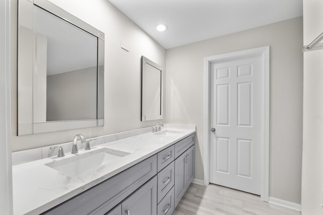 1771 Mission Hills Rd Unit 412, Northbrook, IL 60062 - full bathroom with double vanity, baseboards, wood finished floors, and recessed lighting