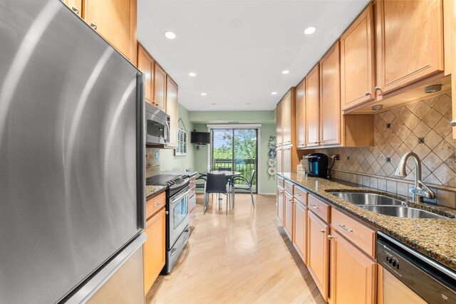 1771 Mission Hills Rd Unit 412, Northbrook, IL 60062 - kitchen featuring stainless steel appliances, a sink, recessed lighting, decorative backsplash, and light wood-type flooring