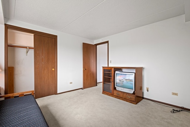 6950 W Forest Preserve Dr Unit 215, Norridge, IL 60706 - unfurnished bedroom with carpet flooring, a closet, baseboards, and a textured ceiling