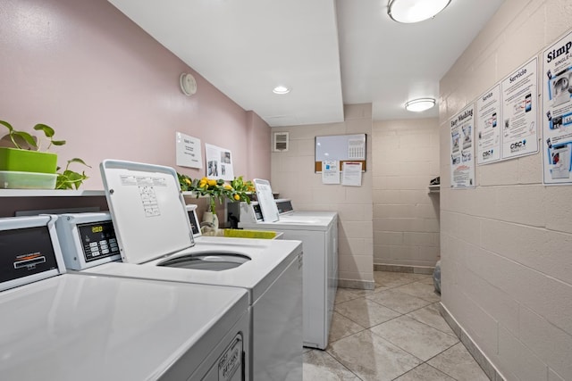 6950 W Forest Preserve Dr Unit 215, Norridge, IL 60706 - communal laundry room with washing machine and dryer, concrete block wall, and light tile patterned floors