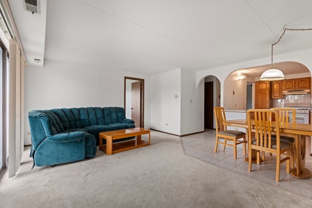 6950 W Forest Preserve Dr Unit 215, Norridge, IL 60706 - dining room with arched walkways, light colored carpet, and baseboards