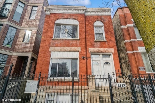 1418 N Campbell Ave, Chicago, IL 60622 - view of property with brick siding, a fenced front yard, and a gate