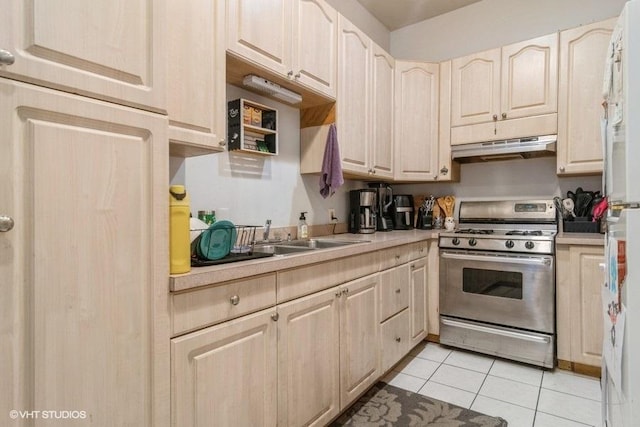 1418 N Campbell Ave, Chicago, IL 60622 - kitchen featuring stainless steel range with gas cooktop, under cabinet range hood, light countertops, and light tile patterned floors