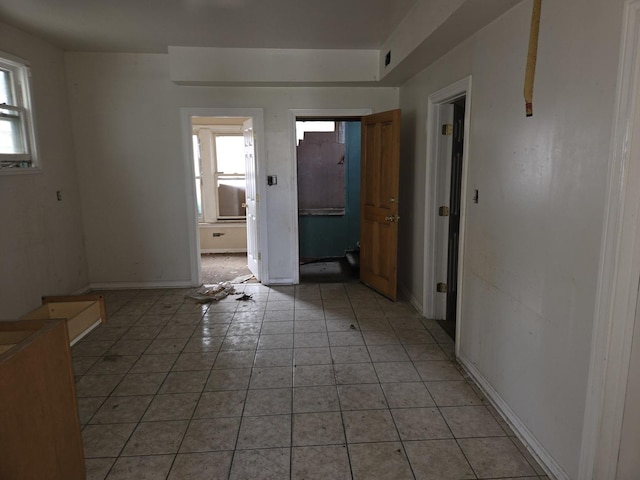 8408 S Baker Ave, Chicago, IL 60617 - unfurnished room with plenty of natural light, light tile patterned floors, and baseboards