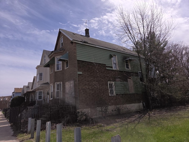 8408 S Baker Ave, Chicago, IL 60617 - view of home's exterior with a chimney and brick siding