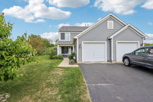 5 Crimson Ct, Lake In The Hills, IL 60156 - traditional-style house featuring asphalt driveway, an attached garage, and a front yard