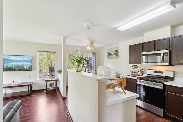 5 Crimson Ct, Lake In The Hills, IL 60156 - kitchen with stainless steel appliances, light countertops, dark brown cabinets, dark wood-style floors, and a ceiling fan
