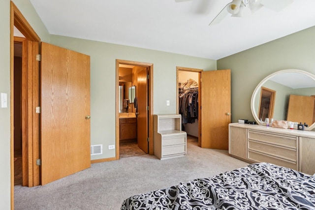 5 Crimson Ct, Lake In The Hills, IL 60156 - bedroom featuring light carpet, a walk in closet, ensuite bath, a closet, and a ceiling fan