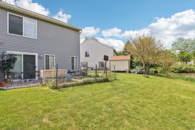 5 Crimson Ct, Lake In The Hills, IL 60156 - rear view of house featuring a vegetable garden and a lawn