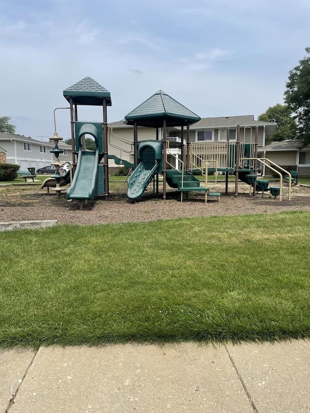 community jungle gym featuring a yard