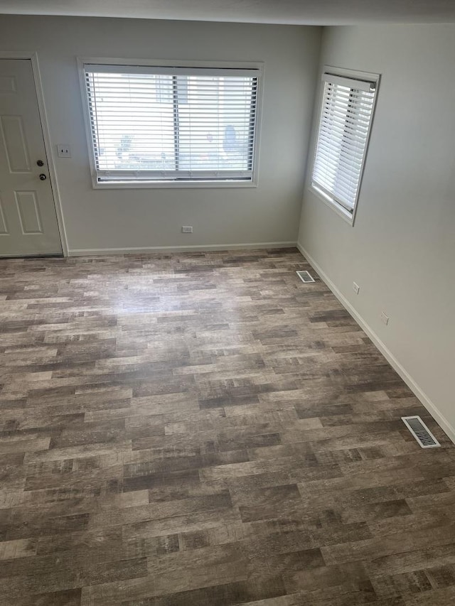 spare room with dark wood-style flooring