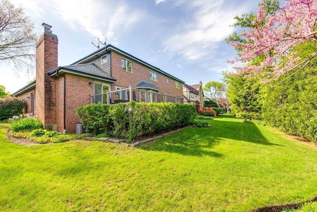 337 S Harrison Ct, Palatine, IL 60067 - view of home's exterior with a chimney, brick siding, and a yard