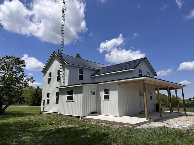 2452 E 350th Rd, Oglesby, IL 61348 - back of house featuring a patio, a yard, and metal roof
