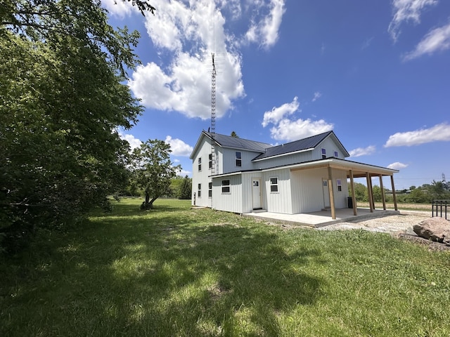 2452 E 350th Rd, Oglesby, IL 61348 - back of property with a patio, a lawn, and metal roof