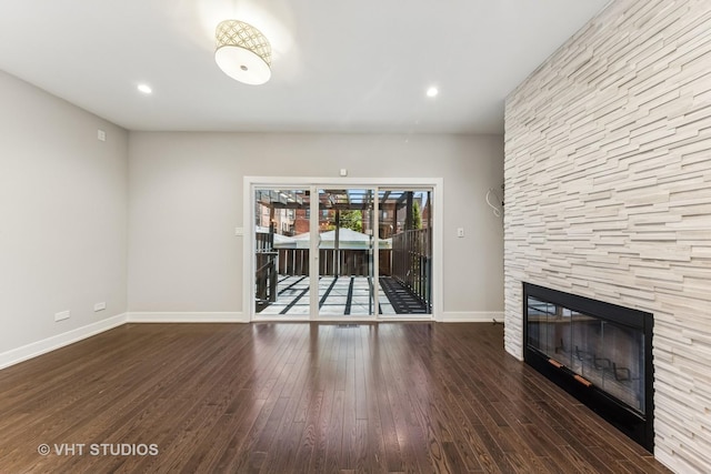 3125 S Giles Ave, Chicago, IL 60616 - unfurnished living room with baseboards, wood finished floors, a stone fireplace, and recessed lighting