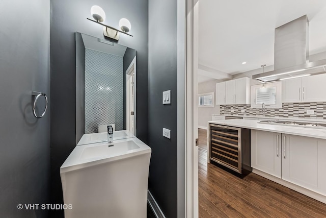 3125 S Giles Ave, Chicago, IL 60616 - bathroom with wine cooler, wood finished floors, vanity, and backsplash