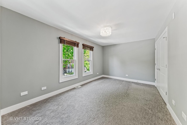 3125 S Giles Ave, Chicago, IL 60616 - carpeted spare room featuring a chandelier and baseboards