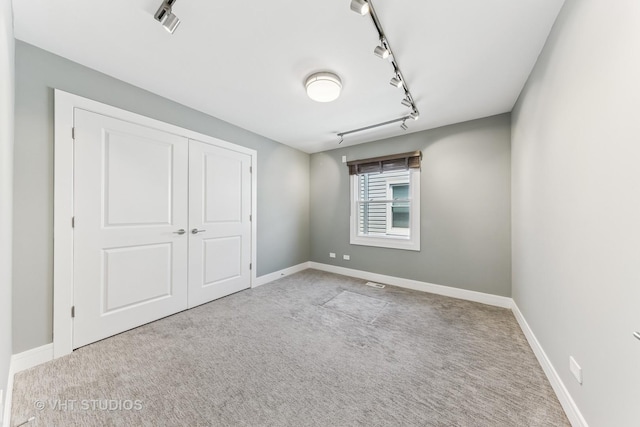 3125 S Giles Ave, Chicago, IL 60616 - unfurnished bedroom featuring track lighting, carpet, and baseboards