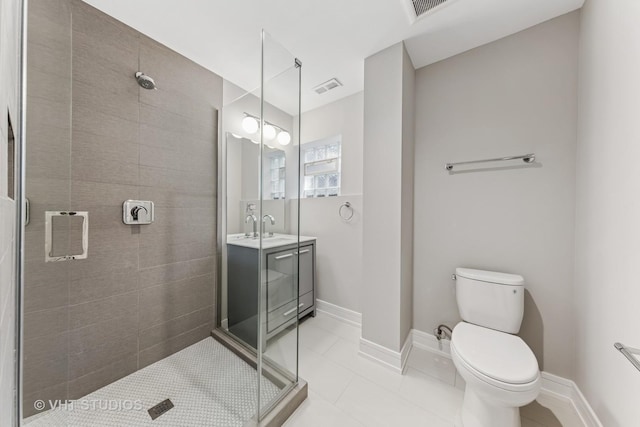 3125 S Giles Ave, Chicago, IL 60616 - full bathroom with a shower stall, toilet, vanity, tile patterned flooring, and baseboards