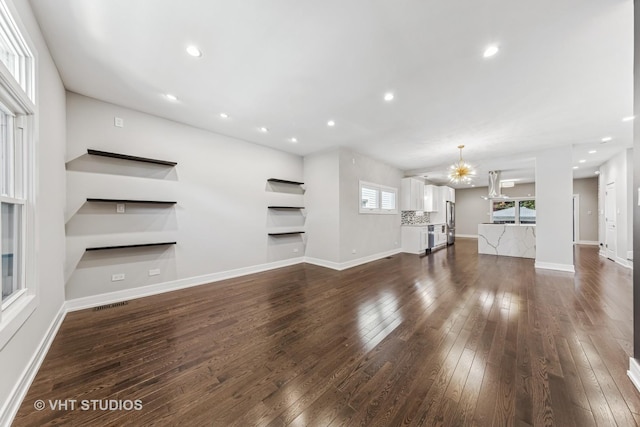 3125 S Giles Ave, Chicago, IL 60616 - unfurnished living room with dark wood finished floors, baseboards, recessed lighting, and a chandelier