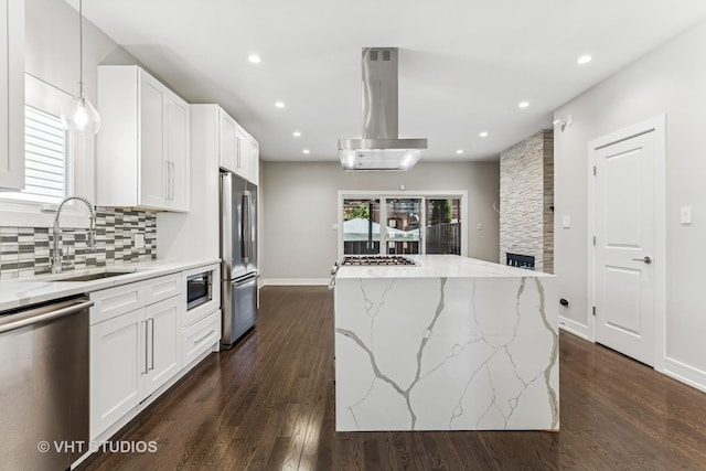3125 S Giles Ave, Chicago, IL 60616 - kitchen with stainless steel appliances, island exhaust hood, a sink, a kitchen island, and dark wood-type flooring