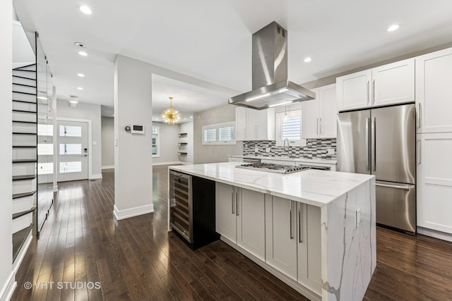 3125 S Giles Ave, Chicago, IL 60616 - kitchen featuring stainless steel appliances, island exhaust hood, a center island, light stone counters, and wine cooler