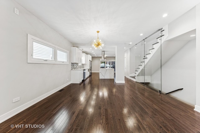 3125 S Giles Ave, Chicago, IL 60616 - unfurnished living room with a chandelier, dark wood-style flooring, stairs, recessed lighting, and baseboards