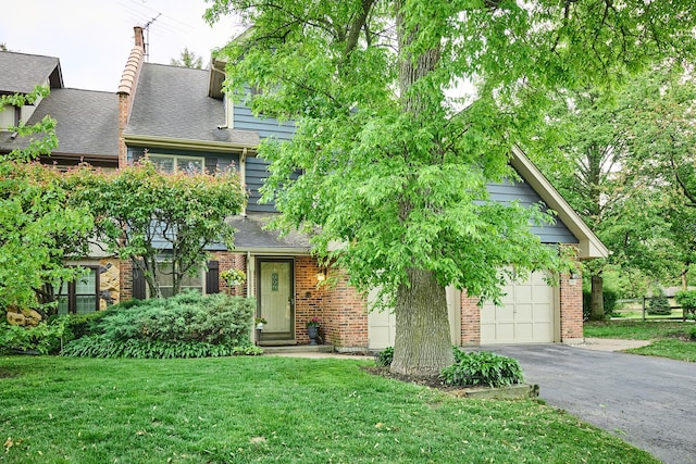202 Country Ln Unit 202, Des Plaines, IL 60016 - view of property hidden behind natural elements with driveway, a front yard, a shingled roof, and brick siding