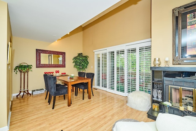 202 Country Ln Unit 202, Des Plaines, IL 60016 - dining area featuring wood finished floors, high vaulted ceiling, and baseboards