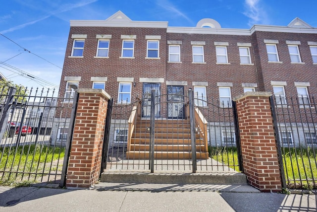 1157 W 19th Pl, Chicago, IL 60608 - view of front of home with brick siding, a fenced front yard, and a gate