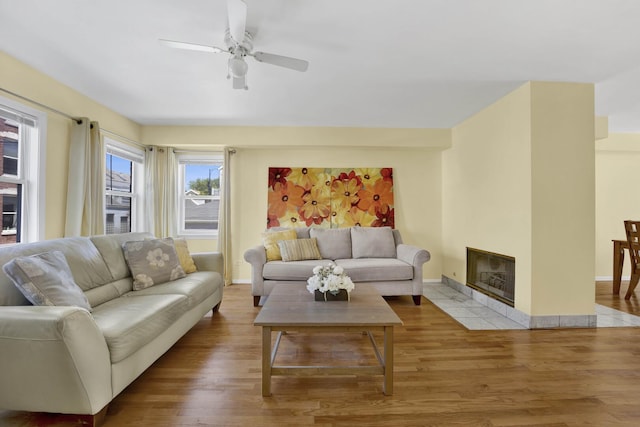 1157 W 19th Pl, Chicago, IL 60608 - living room featuring wood finished floors, a ceiling fan, a fireplace, and baseboards