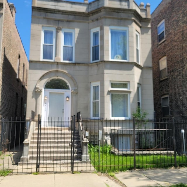 6033 S Prairie Ave, Chicago, IL 60637 - view of front of house featuring a fenced front yard, stone siding, and a gate