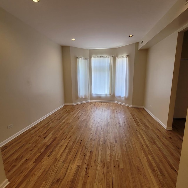 6033 S Prairie Ave, Chicago, IL 60637 - empty room featuring wood finished floors, baseboards, and recessed lighting