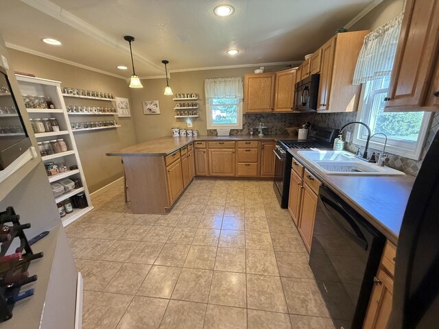 202 17th Ave, Sterling, IL 61081 - kitchen with black appliances, a sink, a peninsula, crown molding, and tasteful backsplash