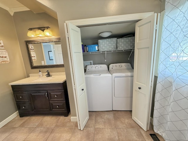 202 17th Ave, Sterling, IL 61081 - laundry room with separate washer and dryer, light tile patterned flooring, and baseboards