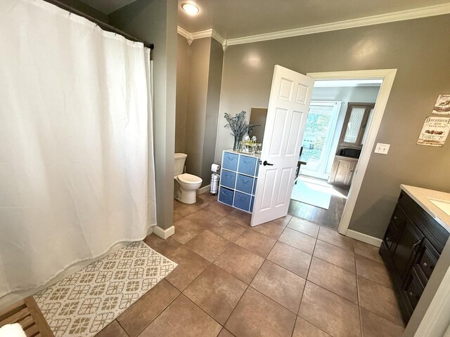 202 17th Ave, Sterling, IL 61081 - full bathroom with crown molding, toilet, vanity, tile patterned floors, and baseboards