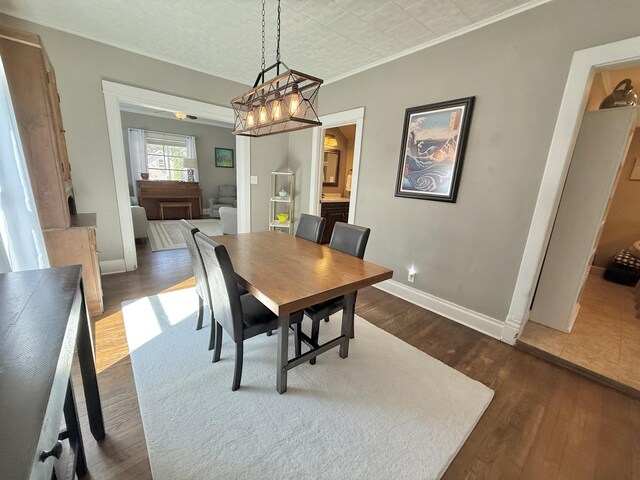 202 17th Ave, Sterling, IL 61081 - dining area featuring ornamental molding, dark wood-style flooring, and baseboards