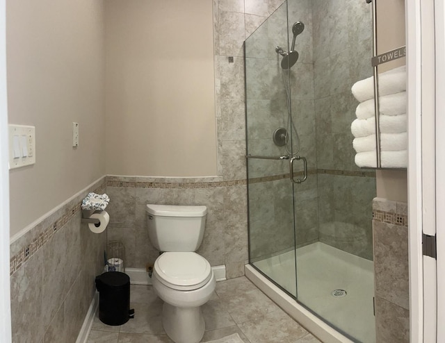 18609 Pinon Trl, Marengo, IL 60152 - full bathroom featuring a stall shower, toilet, a wainscoted wall, tile walls, and tile patterned floors