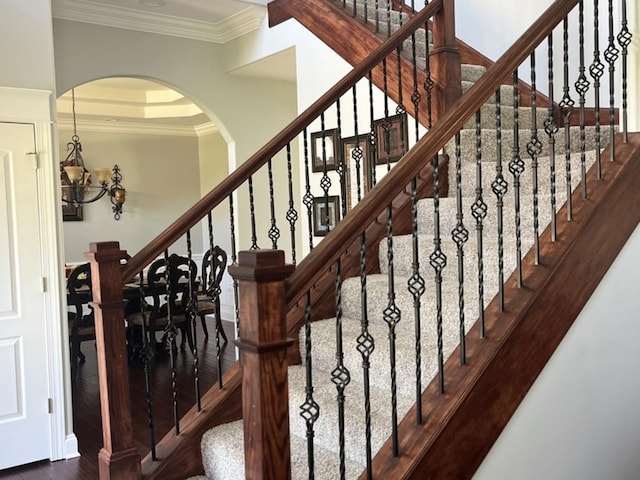 18609 Pinon Trl, Marengo, IL 60152 - stairway with wood finished floors, arched walkways, a chandelier, and crown molding