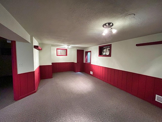 1622 Indian Knoll Rd, Naperville, IL 60565 - finished basement with wainscoting, carpet, a textured ceiling, and wooden walls