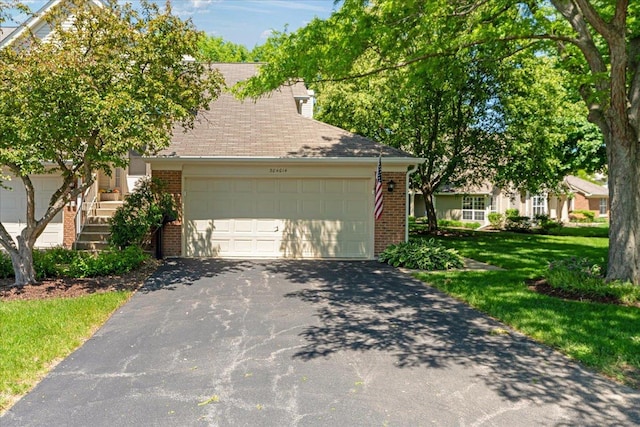 30W014 Willow Ln Unit 1, Warrenville, IL 60555 - view of front of home featuring brick siding, asphalt driveway, an attached garage, and a front yard