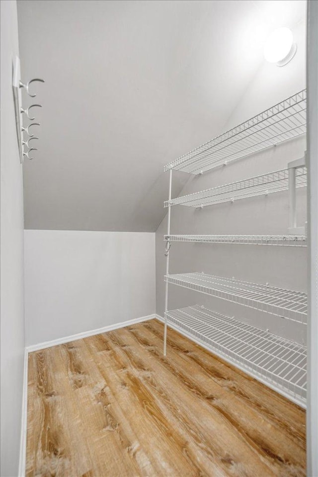 30W014 Willow Ln Unit 1, Warrenville, IL 60555 - walk in closet featuring vaulted ceiling and wood finished floors