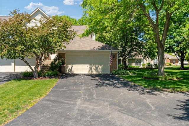 30W014 Willow Ln Unit 1, Warrenville, IL 60555 - obstructed view of property featuring brick siding, asphalt driveway, a garage, and a front lawn