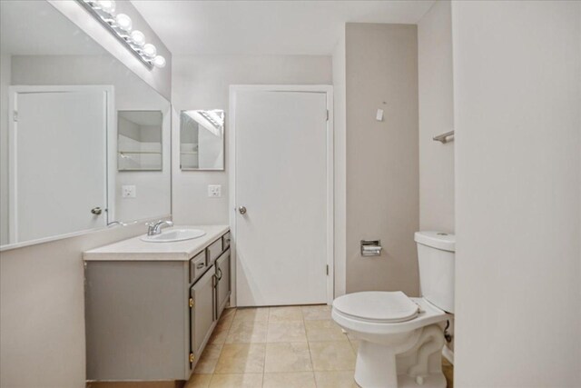 30W014 Willow Ln Unit 1, Warrenville, IL 60555 - bathroom featuring vanity, toilet, and tile patterned flooring