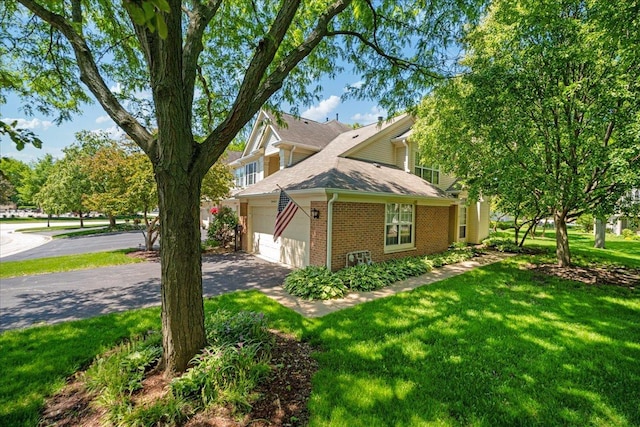30W014 Willow Ln Unit 1, Warrenville, IL 60555 - view of home's exterior featuring brick siding, driveway, a lawn, and roof with shingles
