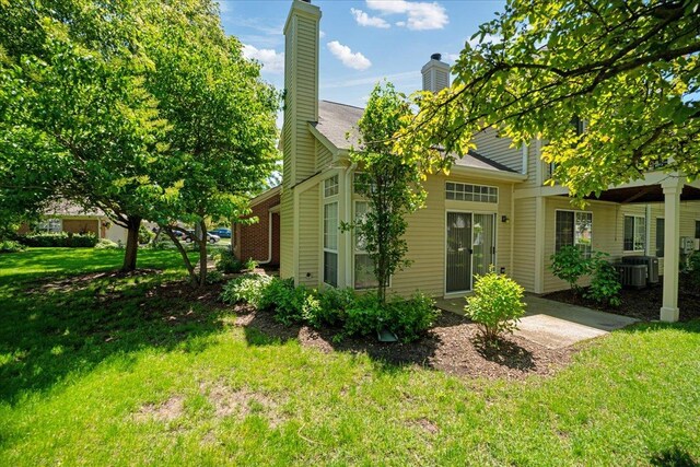 30W014 Willow Ln Unit 1, Warrenville, IL 60555 - view of home's exterior with a yard, a chimney, cooling unit, and a patio area