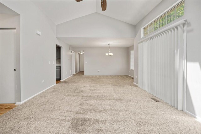 30W014 Willow Ln Unit 1, Warrenville, IL 60555 - unfurnished living room with ceiling fan, a chandelier, carpet flooring, vaulted ceiling, and baseboards